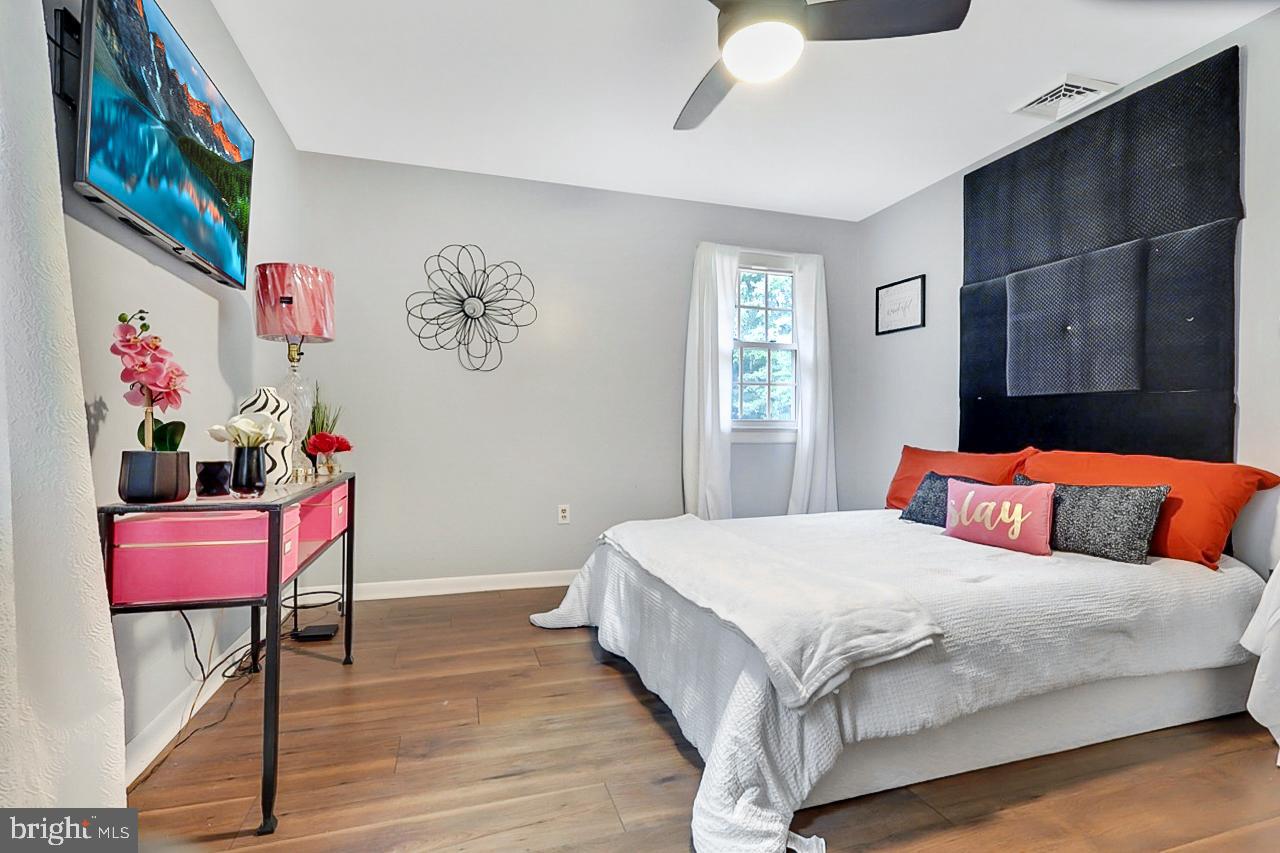 38340 Sugar Hole Road Avenue, MD 20609 - Photo 12 of 32 a bedroom with a bed and wooden floor