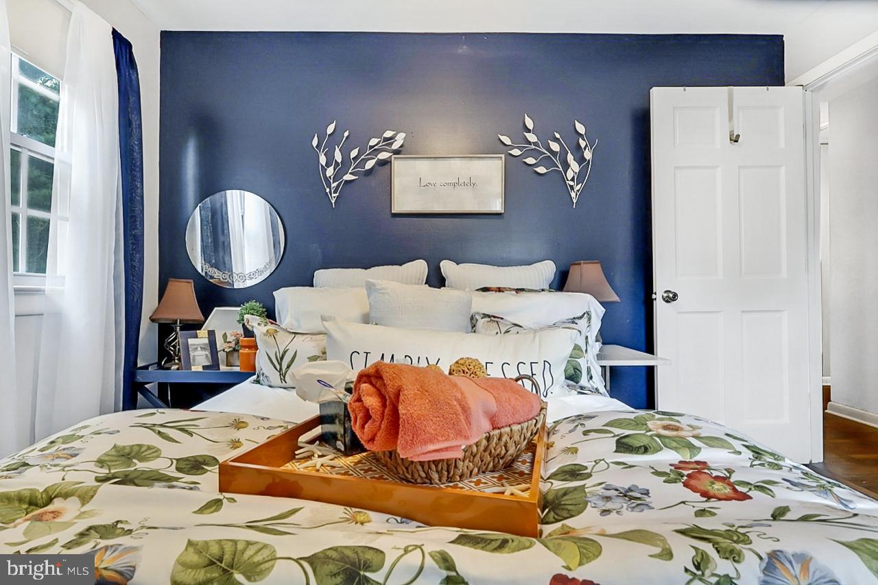 38340 Sugar Hole Road Avenue, MD 20609 - Photo 15 of 32 a bedroom with a bed and a chandelier