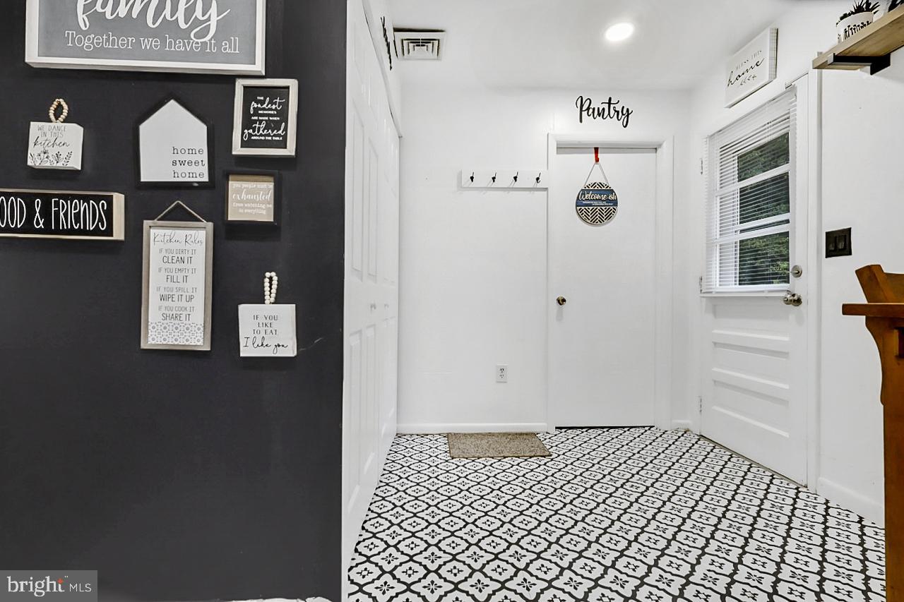 38340 Sugar Hole Road Avenue, MD 20609 - Photo 17 of 32 a view of a hallway with wooden floor and cabinets