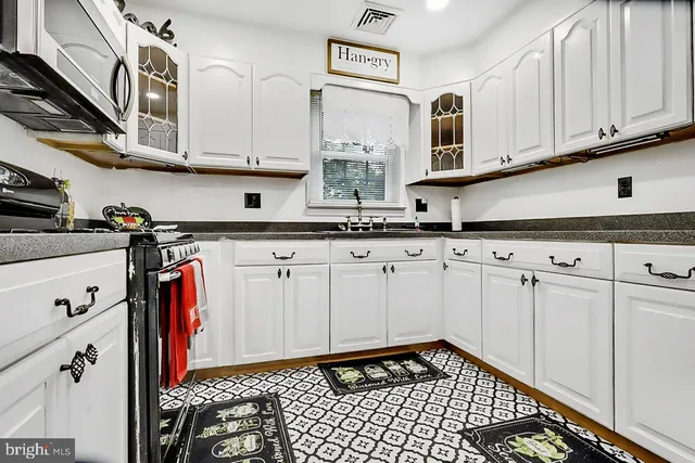 a view of a house with a yard and deck