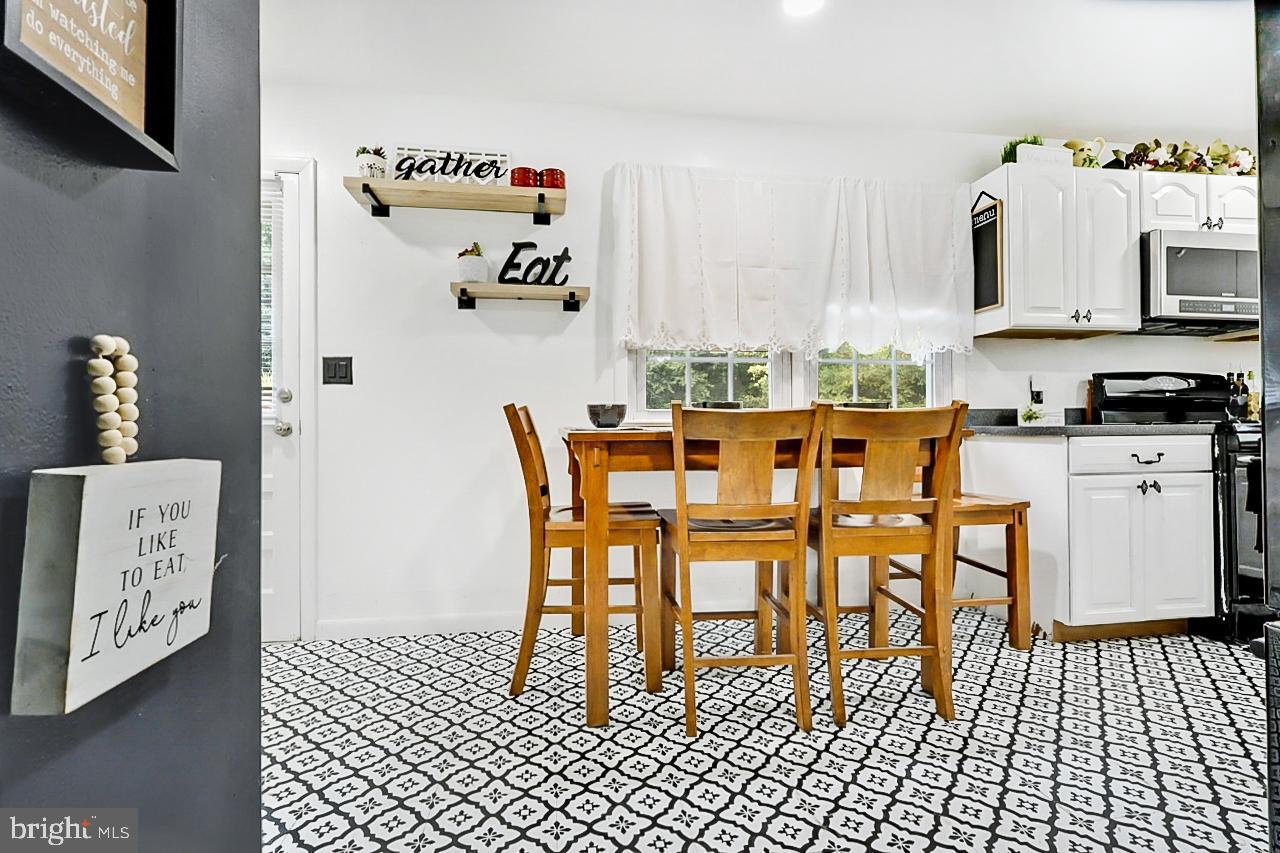 38340 Sugar Hole Road Avenue, MD 20609 - Photo 5 of 32 a dining room with furniture and a flat screen tv