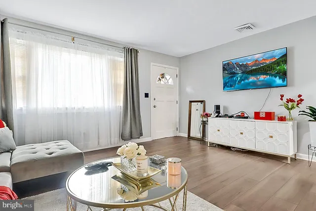 a living room with furniture and wooden floor