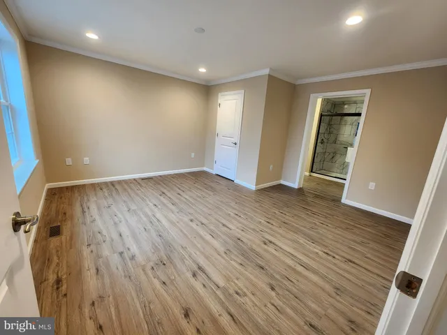 a bathroom with a glass shower door and a window