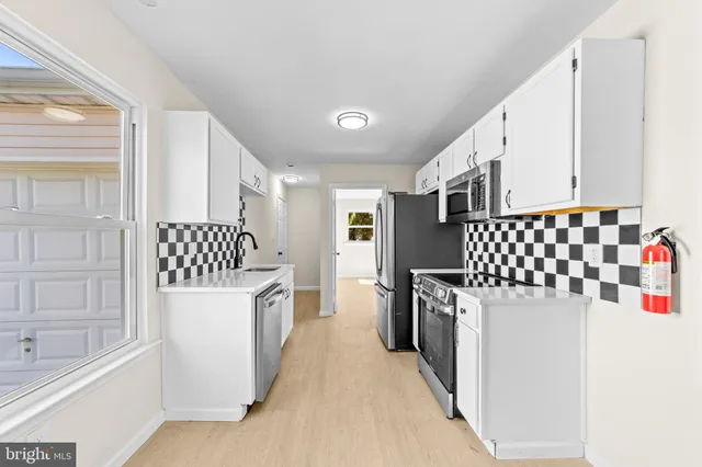 a kitchen with a refrigerator and a sink