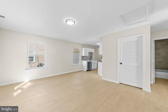 a view of a livingroom with a kitchen and a sink