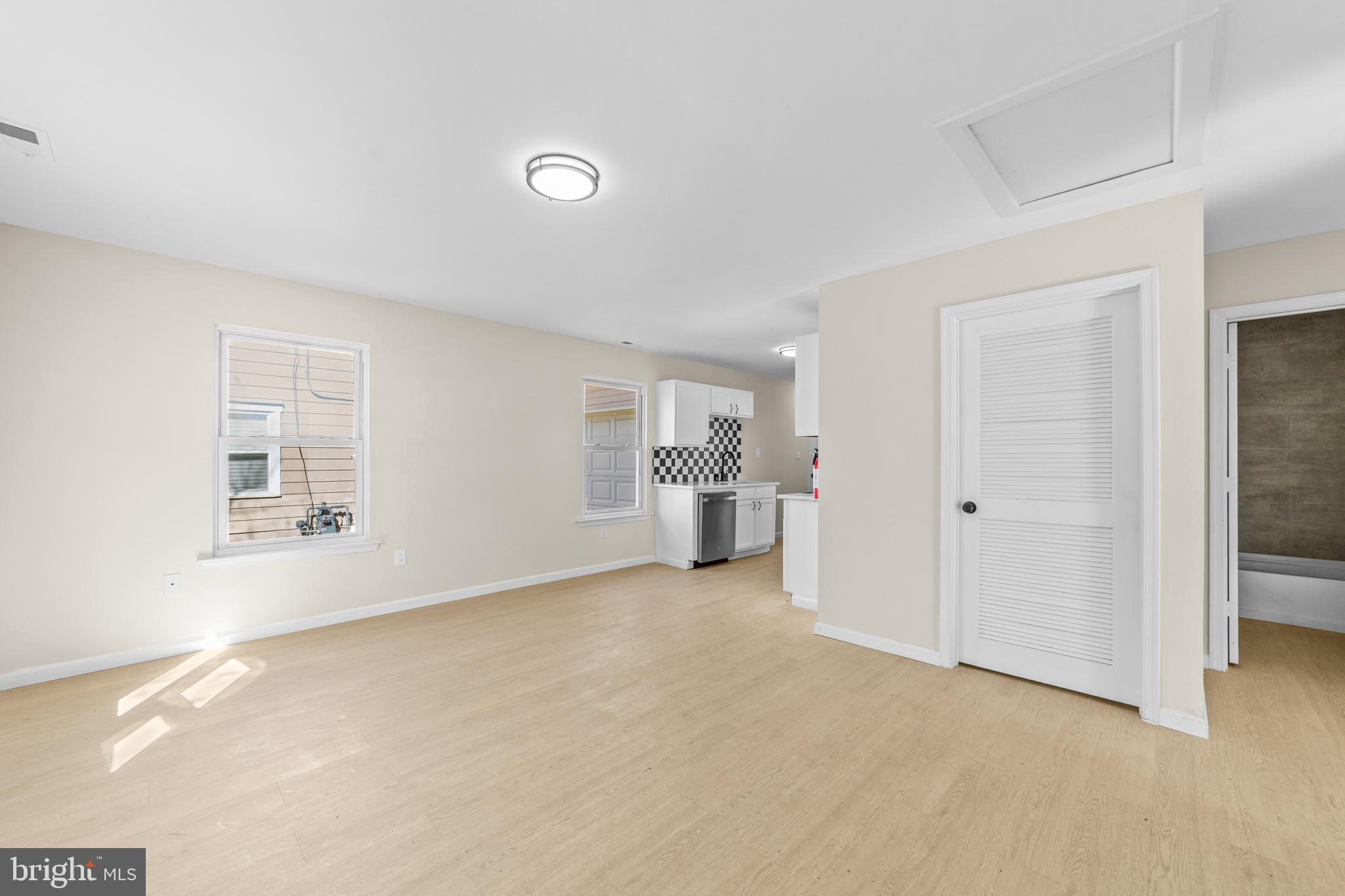33 Pinewood Avenue Carneys Point, NJ 08069 - Photo 7 of 24 a view of a livingroom with a kitchen and a sink