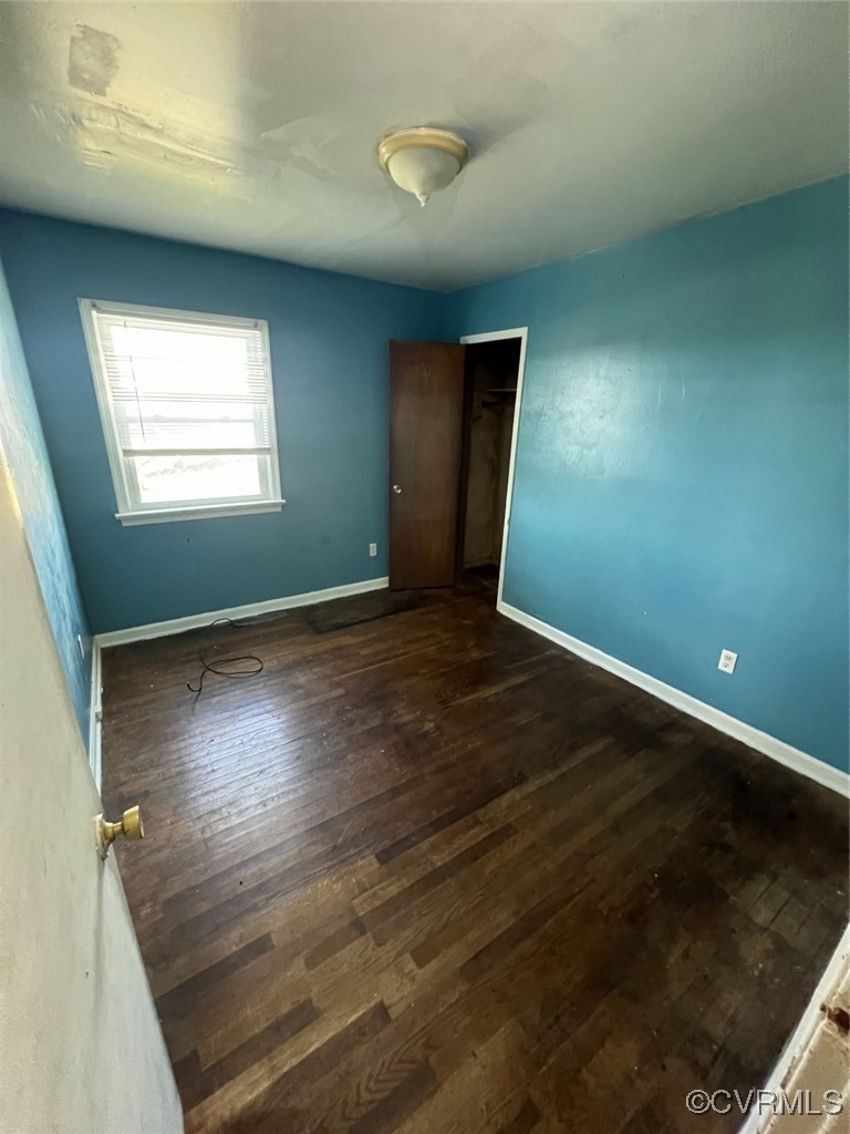 2502 Dry Bread Road Emporia, VA 23847 - Photo 12 of 14 an empty room with wooden floor and windows