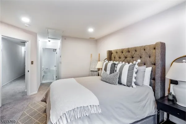 a bedroom with a large bed and a chandelier