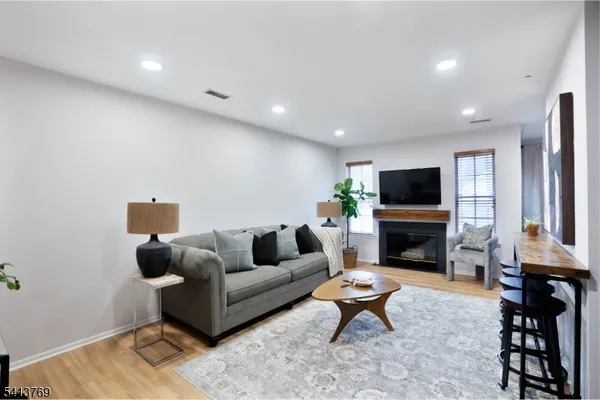 a living room with furniture a fireplace and a flat screen tv
