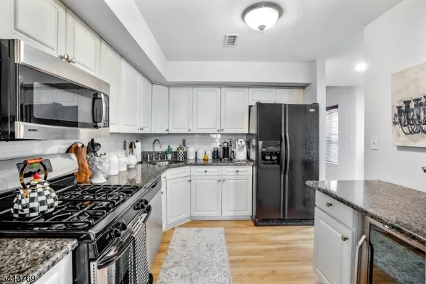 a kitchen with a stove a sink and a refrigerator
