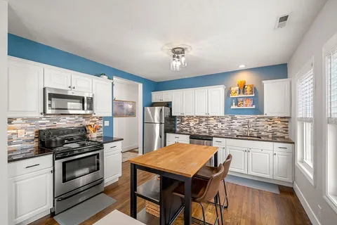 a kitchen with a stove a sink and a refrigerator