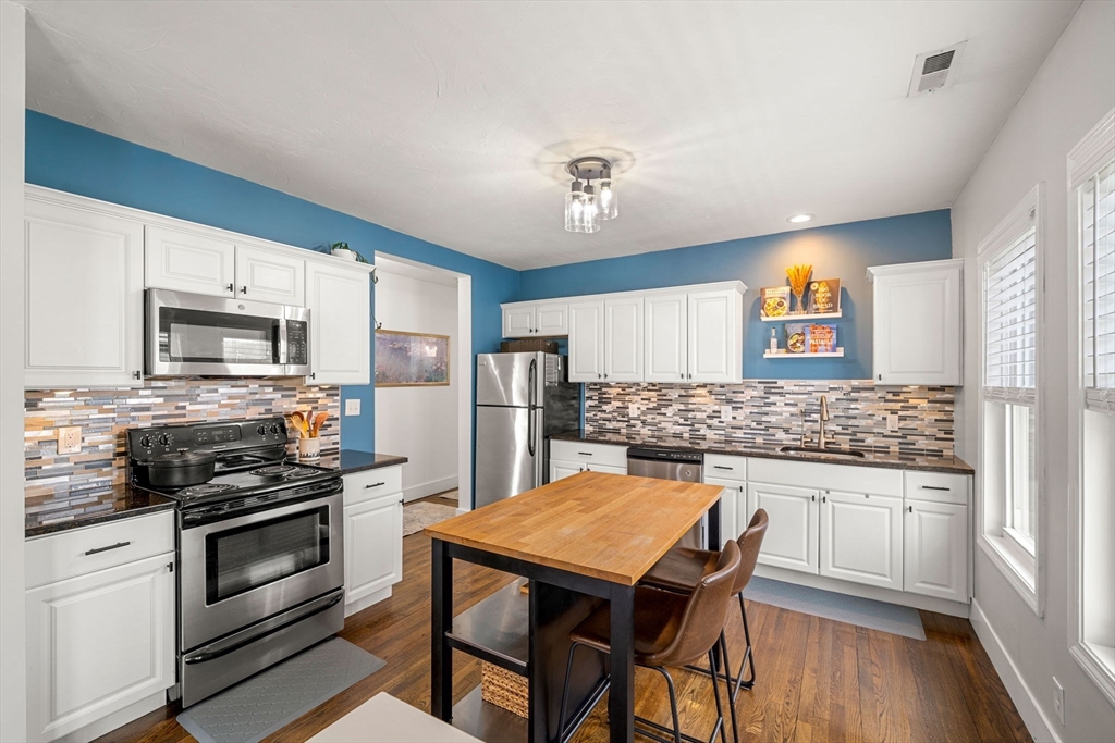 104 Stetson Avenue, Unit 2 Swampscott, MA 01907 - Photo 11 of 33 a kitchen with a stove a sink and a refrigerator