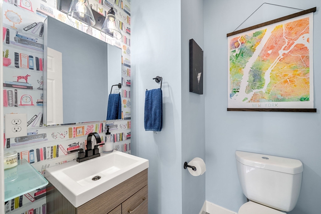 104 Stetson Avenue, Unit 2 Swampscott, MA 01907 - Photo 20 of 33 a bathroom with a sink mirror and toilet
