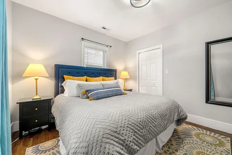a bedroom with a bed and a lamp