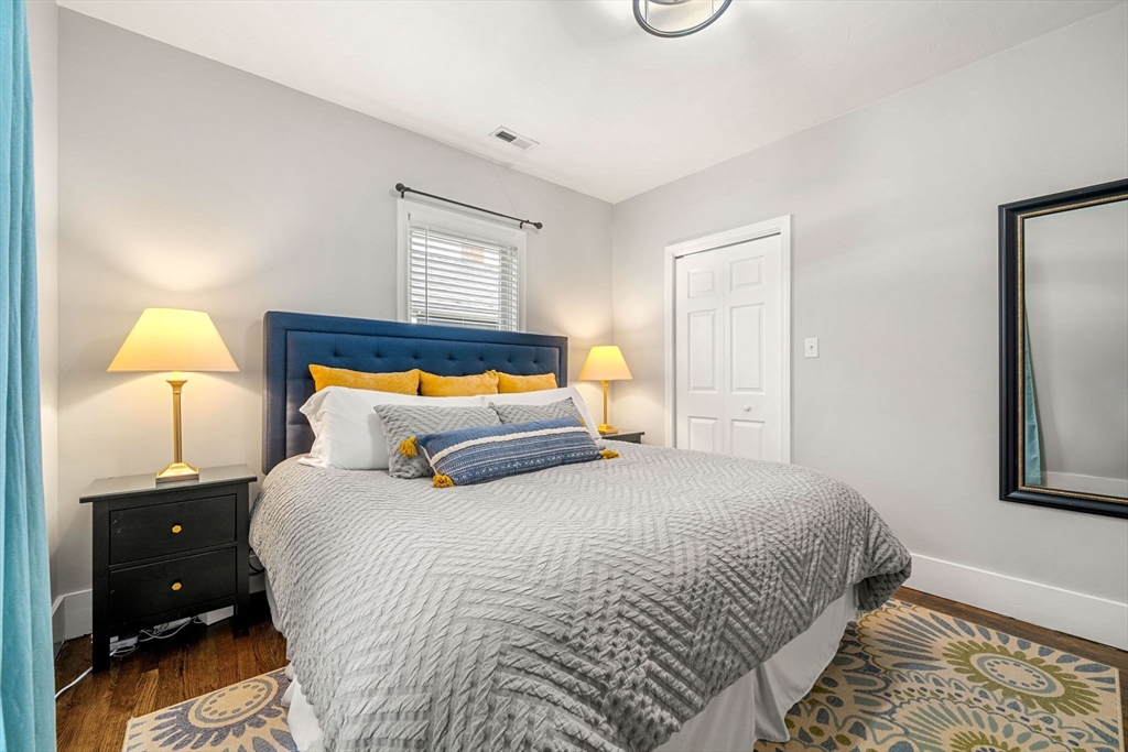 104 Stetson Avenue, Unit 2 Swampscott, MA 01907 - Photo 21 of 33 a bedroom with a bed and a lamp