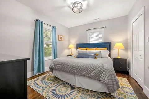 a bedroom with a bed and wooden floor