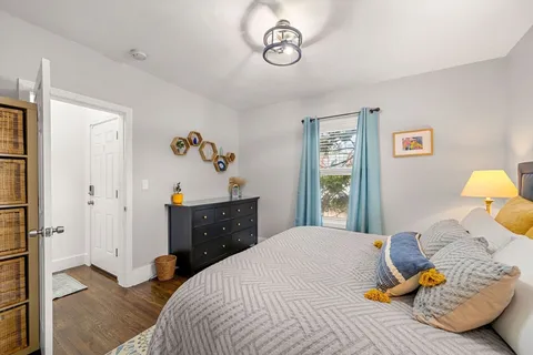 a bedroom with a bed and a window