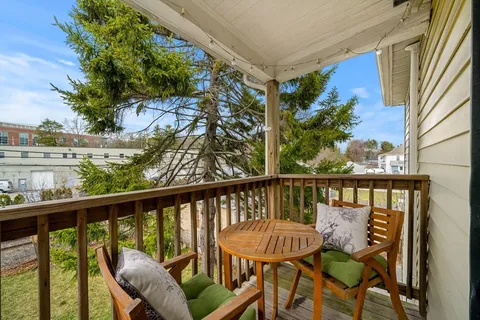 a view of a chair and table in the balcony