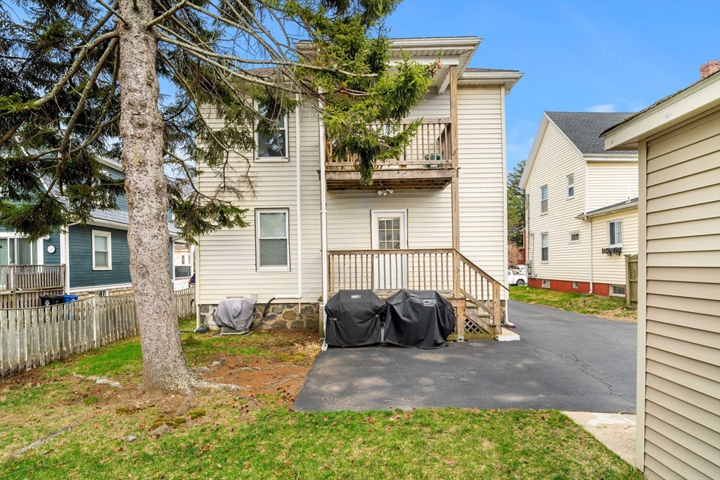 104 Stetson Avenue, Unit 2 Swampscott, MA 01907 - Photo 29 of 33 a view of a yard with brick house and a large tree