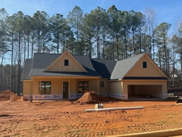 a front view of a house with a yard covered in snow