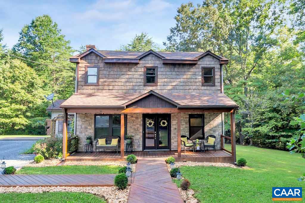 a front view of a house with garden and porch