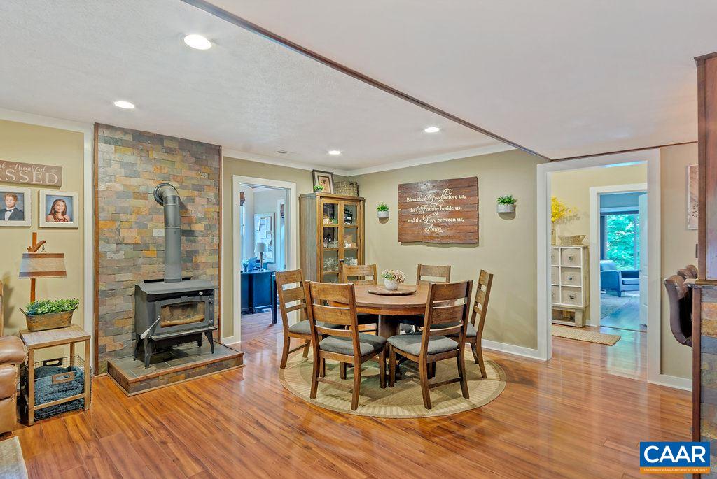 2523 Ridge Road Palmyra, VA 22963 - Photo 11 of 44 a dining room with furniture a fireplace and wooden floor