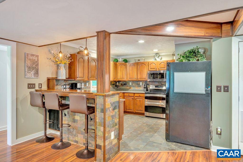 2523 Ridge Road Palmyra, VA 22963 - Photo 12 of 44 a kitchen with stainless steel appliances kitchen island granite countertop a refrigerator and cabinets