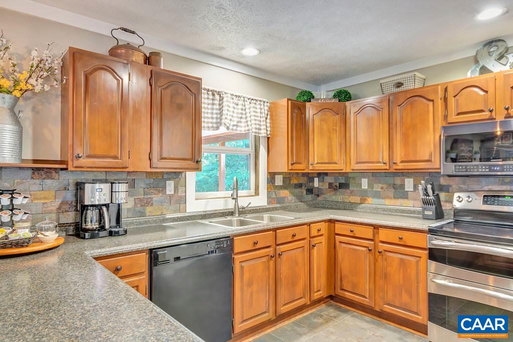 2523 Ridge Road Palmyra, VA 22963 - Photo 13 of 44 a kitchen with stainless steel appliances granite countertop a sink a stove cabinets counter space and a window