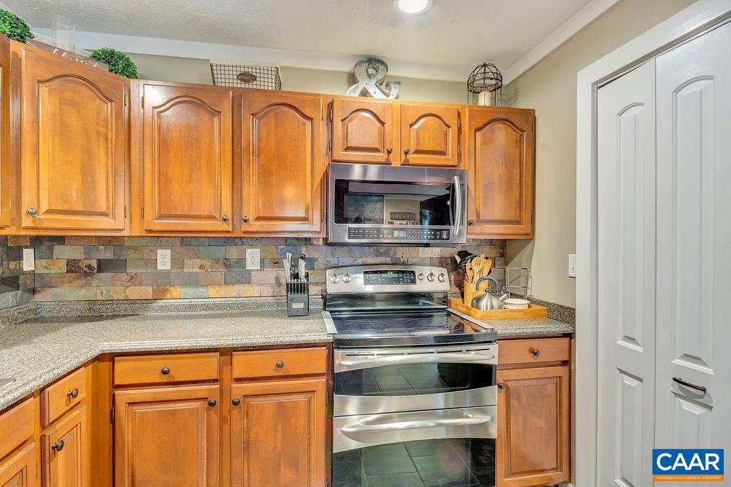 2523 Ridge Road Palmyra, VA 22963 - Photo 14 of 44 a kitchen with stainless steel appliances granite countertop a stove a sink and a microwave