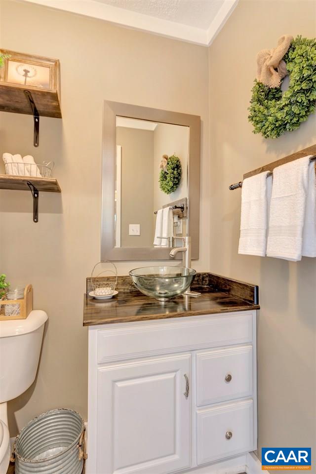 2523 Ridge Road Palmyra, VA 22963 - Photo 18 of 44 a bathroom with a granite countertop toilet sink and mirror