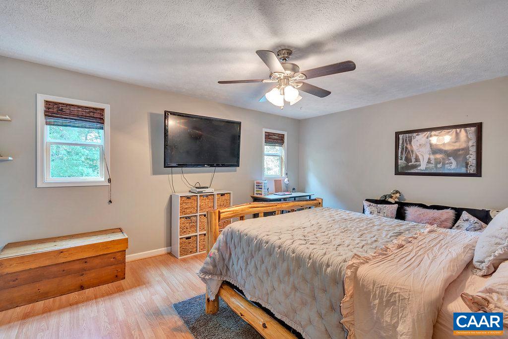 2523 Ridge Road Palmyra, VA 22963 - Photo 24 of 44 a bedroom with a bed and a flat screen tv