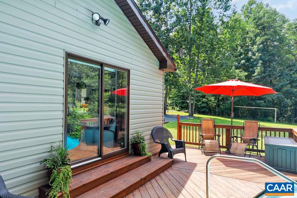 2523 Ridge Road Palmyra, VA 22963 - Photo 32 of 44 an outdoor sitting area with furniture and umbrella