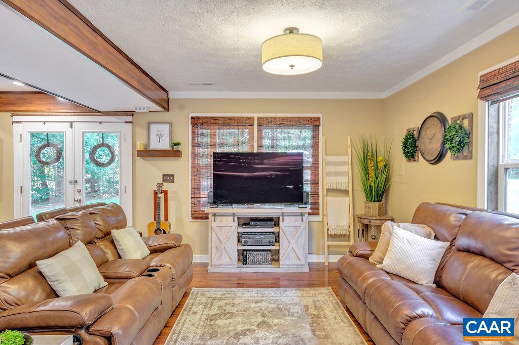 2523 Ridge Road Palmyra, VA 22963 - Photo 6 of 44 a living room with furniture a fireplace and a flat screen tv