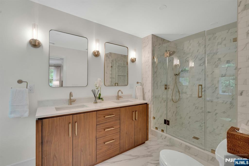48 Hopper Farm Road Upper Saddle River, NJ 07458 - Photo 27 of 43 a bathroom with a granite countertop sink toilet mirror and shower