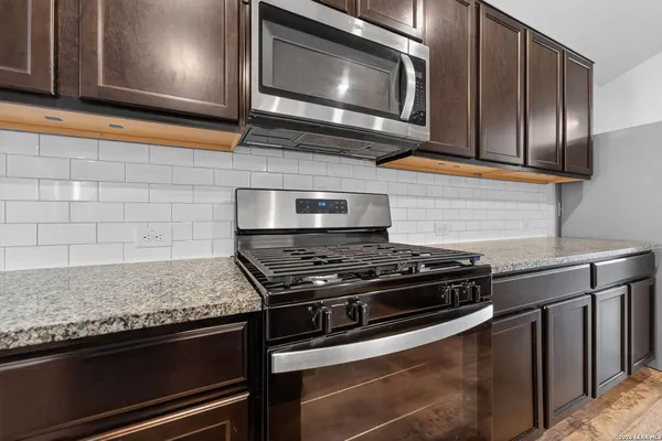 a stove top oven sitting inside of a kitchen