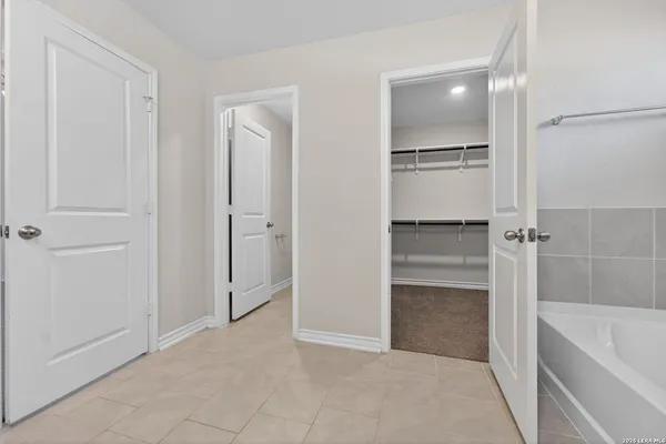 a spacious bathroom with a tub and shower