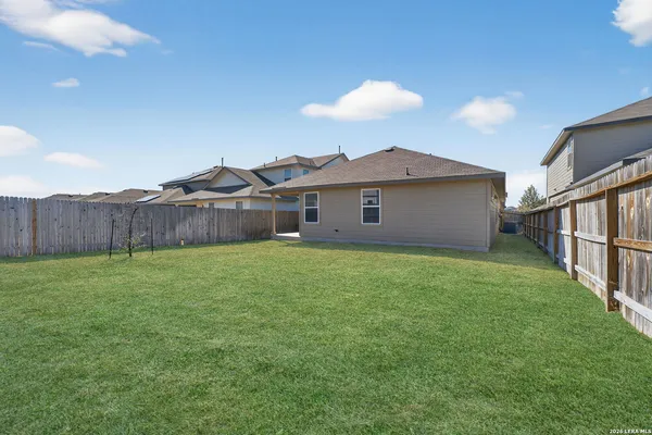 a view of a house with a backyard