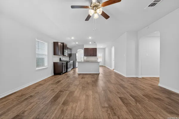 a view of a kitchen with a stove cabinets and wooden floor