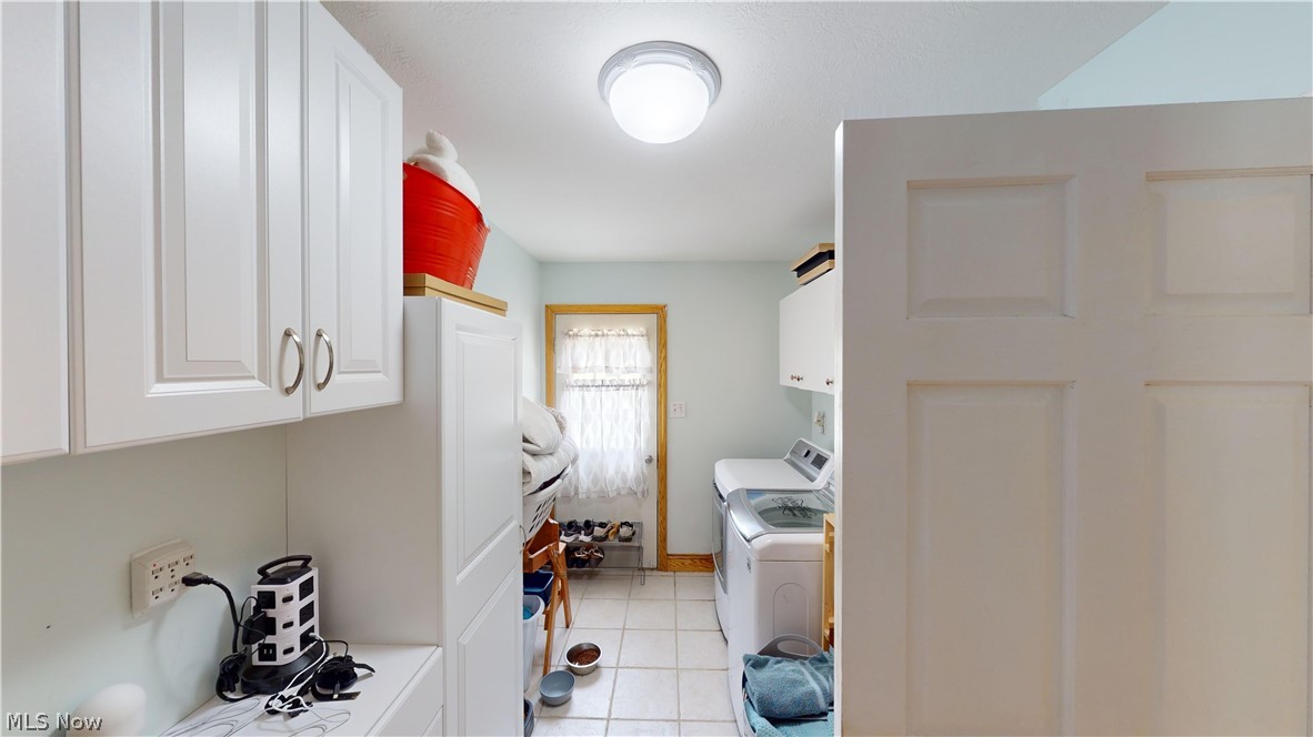 290 McIntosh Road Chester, WV 26034 - Photo 6 of 43 Clothes washing area with cabinets, separate washer and dryer, and light tile patterned floors