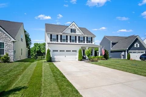 a front view of a house with a yard and porch