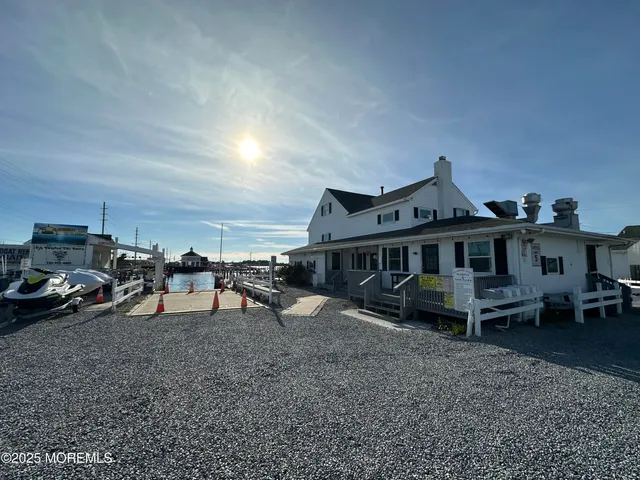 a view of a house with patio furniture and a yard