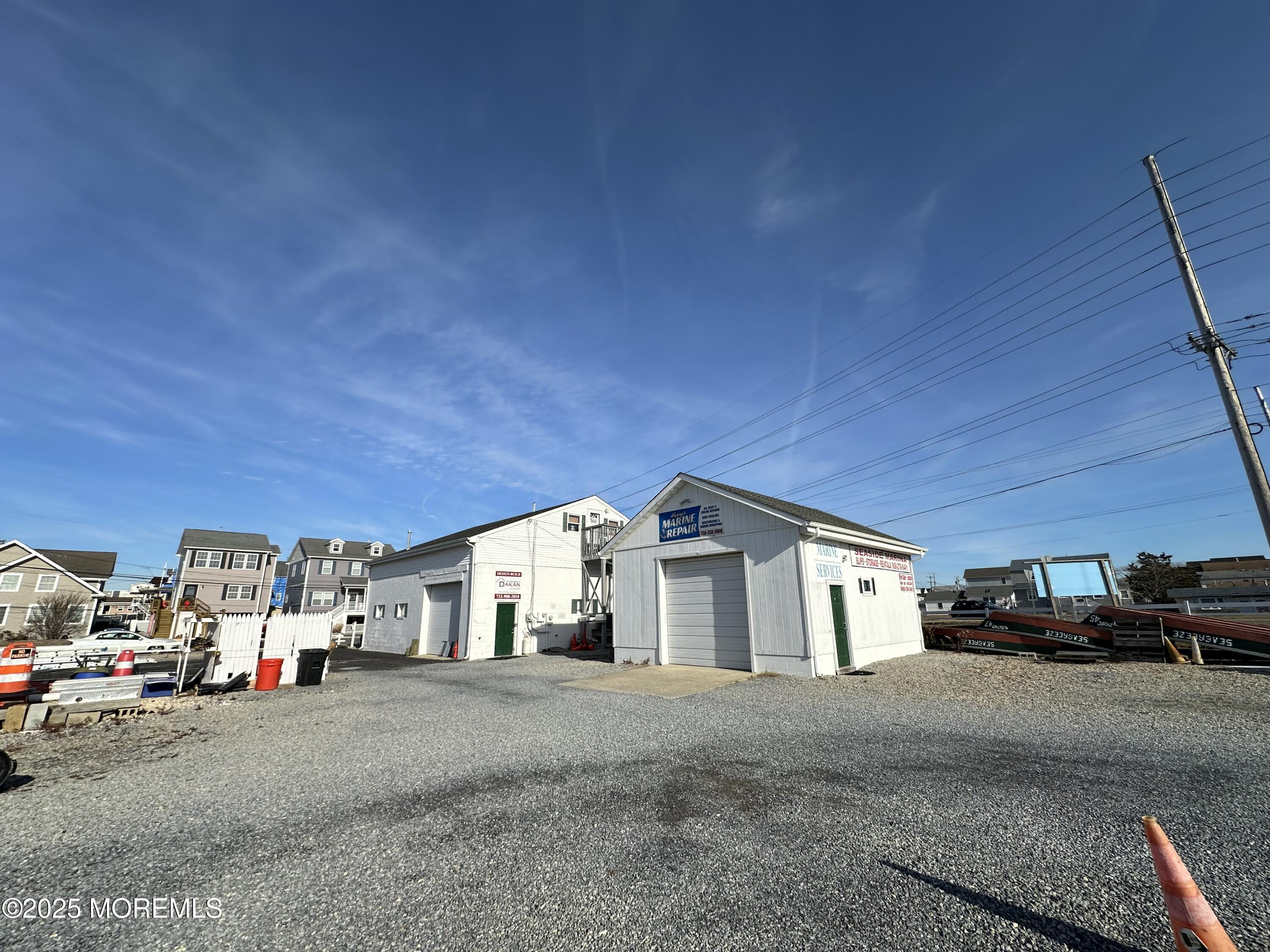 Bayside Terrace Seaside Heights, NJ 08751 - Photo 13 of 13 a view of garage with parked cars