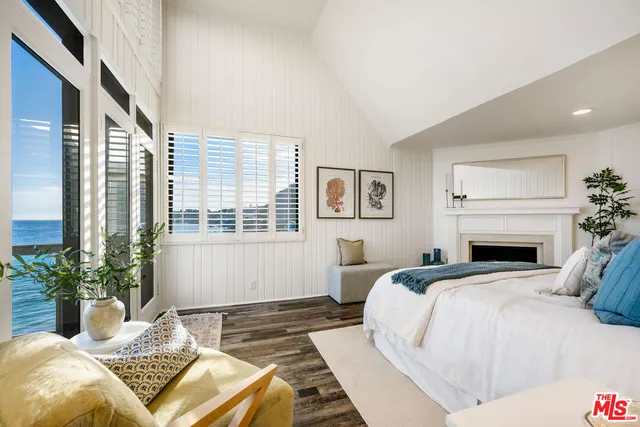 a bedroom with a bed and a potted plant