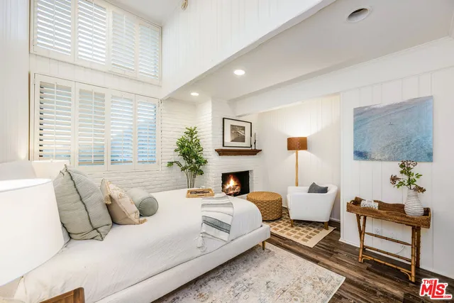 a living room with furniture large window and lamp