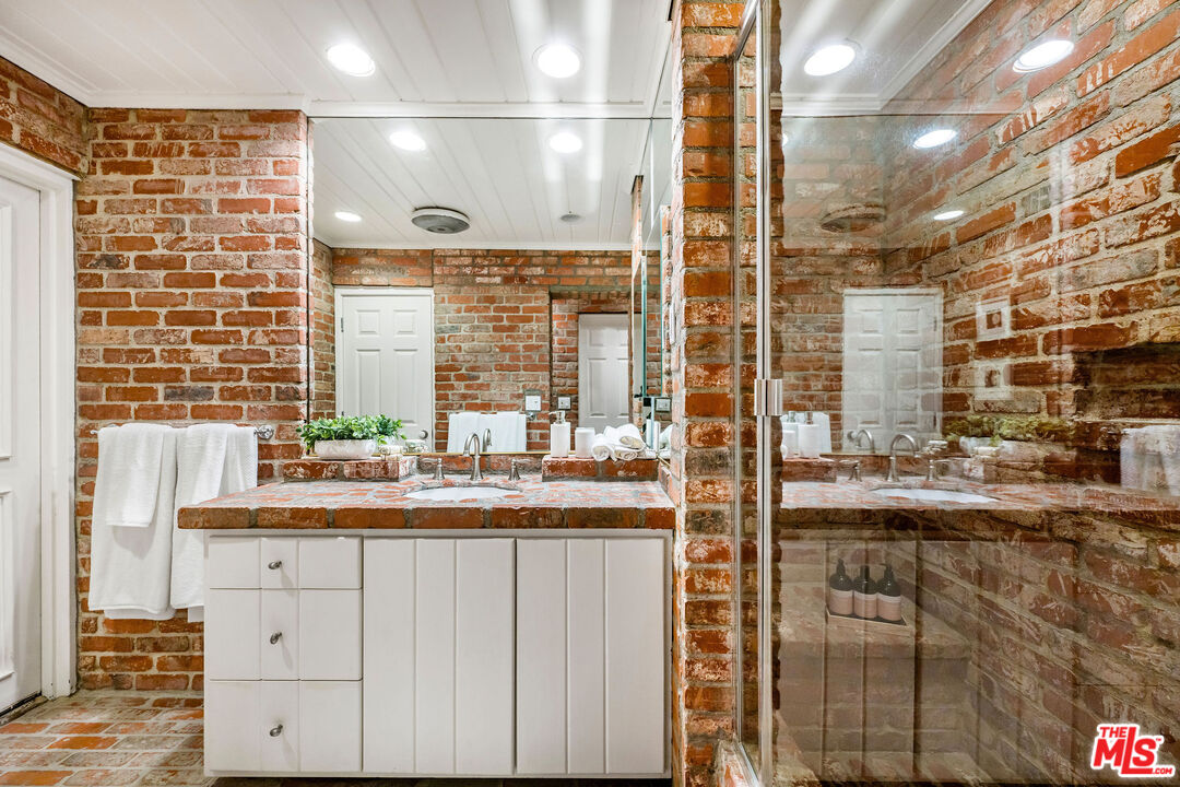 26174 Pacific Coast Highway Malibu, CA 90265 - Photo 19 of 33 a bathroom with a double vanity sink and a mirror
