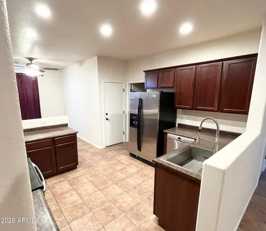 a kitchen with stainless steel appliances granite countertop a refrigerator and a stove