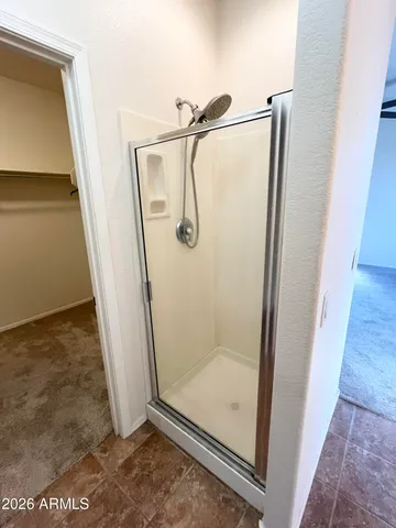 a bathroom with a glass shower door