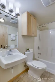 a bathroom with a sink toilet and shower