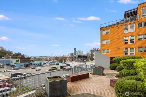a view of a patio with couches and city view