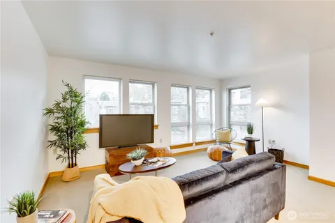 a living room with furniture and floor to ceiling window